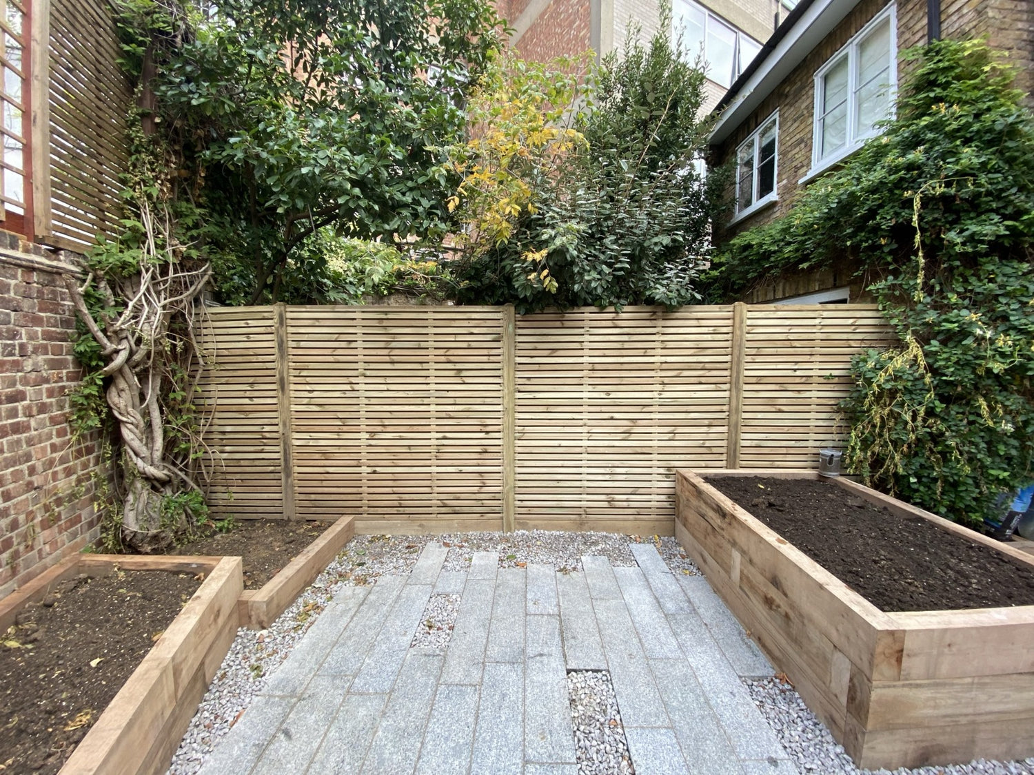 Landscaped garden, double slatted fence panel with railway sleeper planters